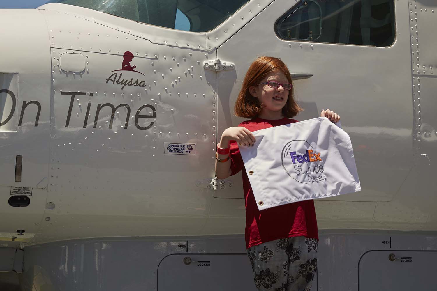 Alyssa posing with the FedEx Cessna Caravan plane. Photo by FedEx.