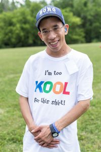 Sam KdVS Young adult male diagnosed with Koolen-de Vries Syndrome weaing a "I'm too KOOL for this shirt" shirt